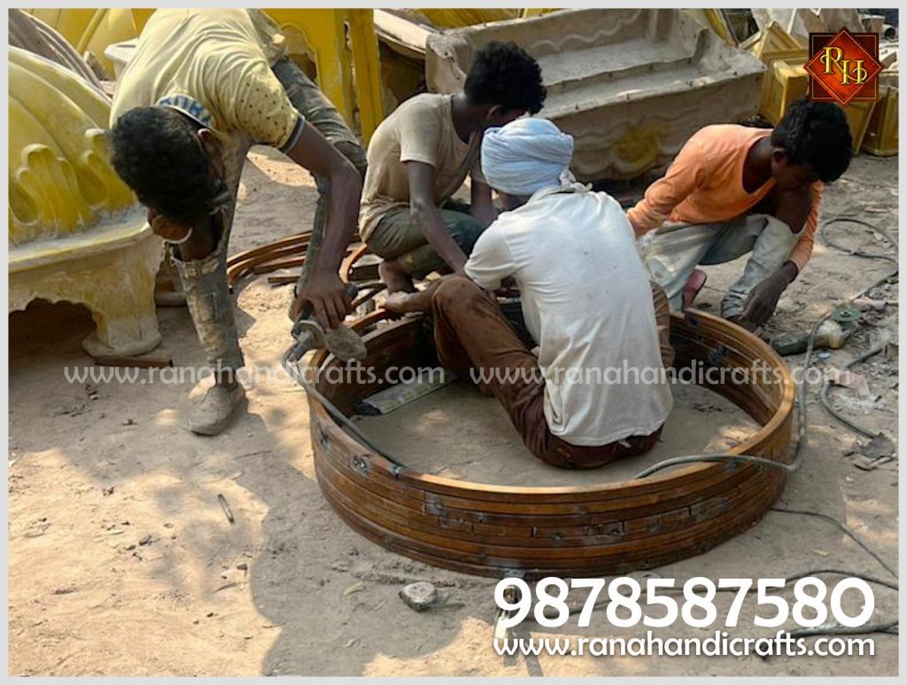 Technicians assembling the base MS frame structure rings for a 5ft diameter dome at Rana Handicrafts International