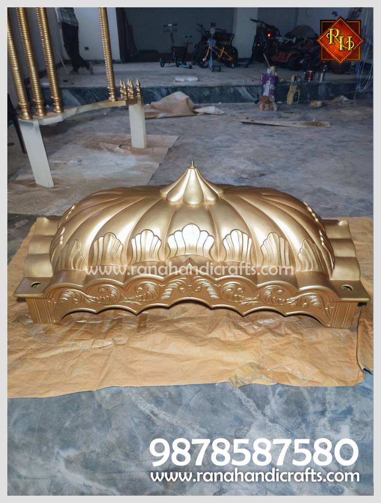 Close-up of the intricately carved, golden-colored dome of a Palki Sahib, constructed from silicon fiber.
