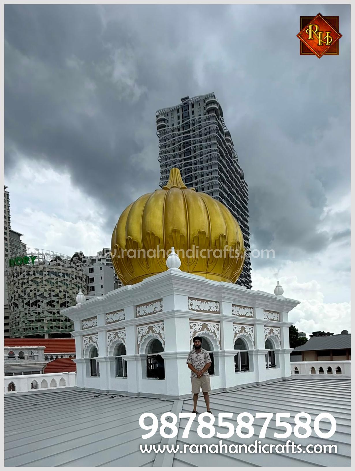 Uday Veer Singh Rana posing on the rooftop next to the completed 20ft golden dome installation at Wadda Gurdwara Sahib, Penang, manufactured by Rana Handicrafts International.