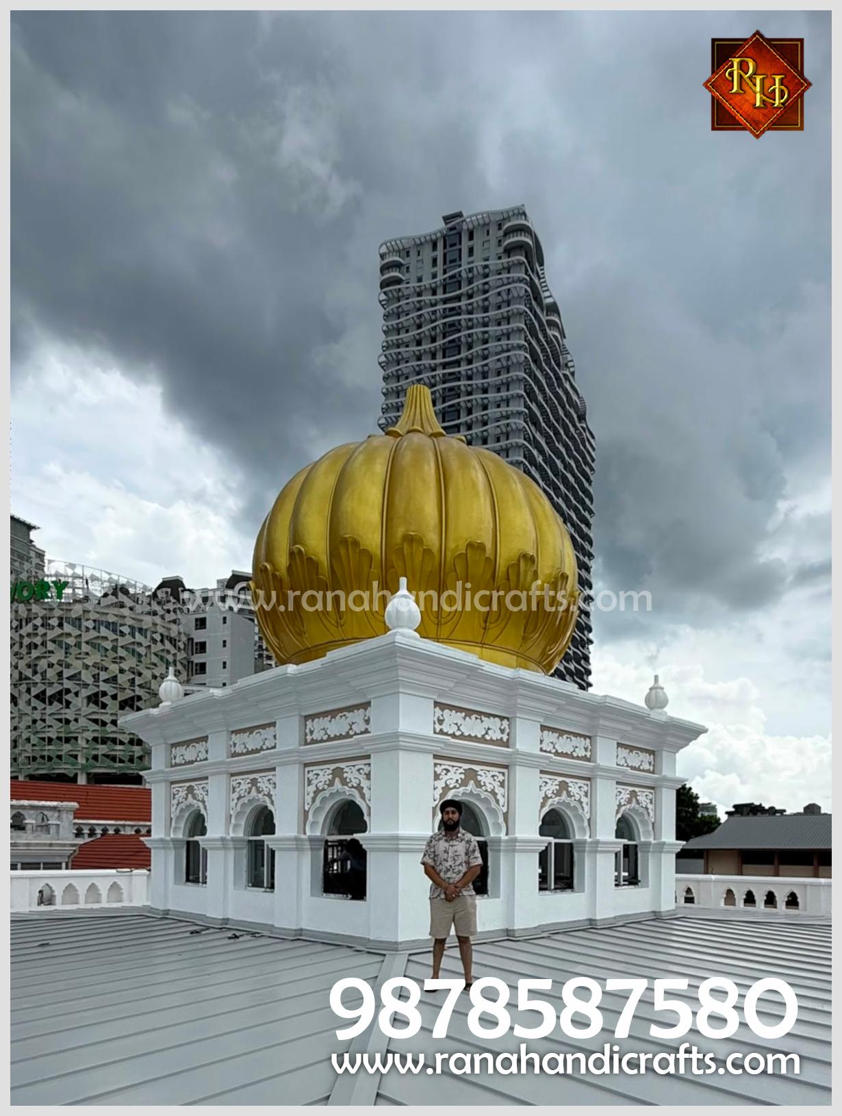 A wide shot of Uday Veer Singh Rana next to the massive 20ft golden dome at Wadda Gurdwara Sahib, Penang, verifying the expert installation by Rana Handicrafts International.