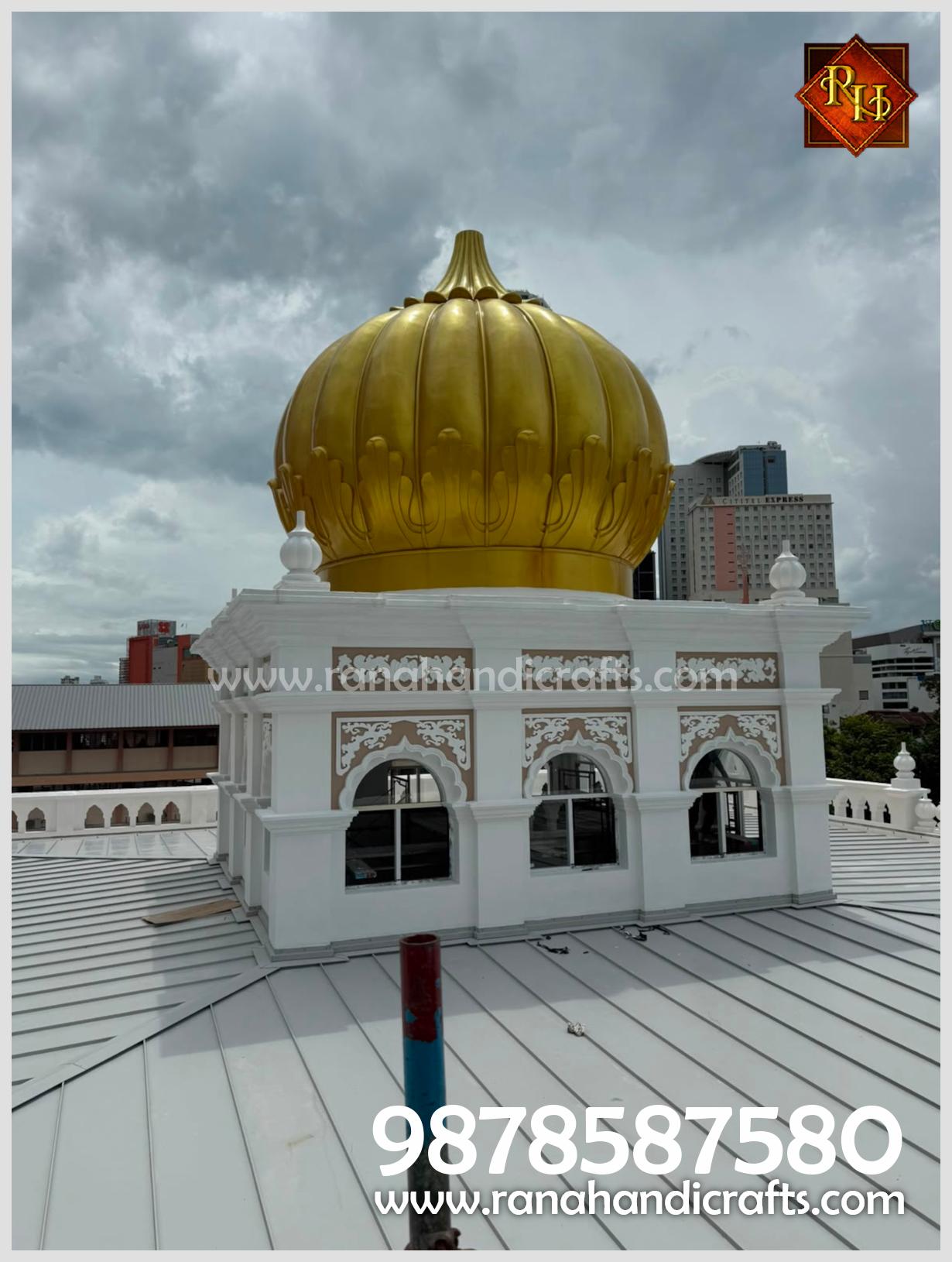 Close-up view of the golden dome and its ornate white base installed at Wadda Gurdwara Sahib Penang, crafted from high-quality silicon fiber reinforced with an MS frame structure by Rana Handicrafts International.