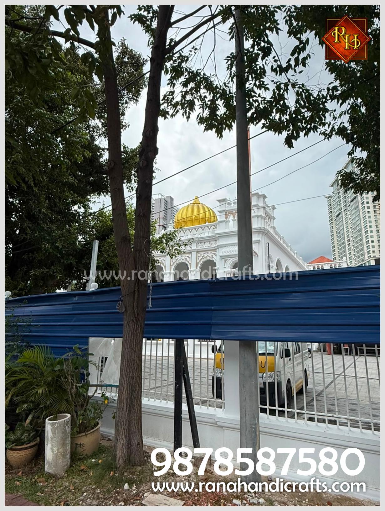 An exterior view from street level looking up at the newly installed golden dome atop the Wadda Gurdwara Sahib Penang, a project completed by Rana Handicrafts International.