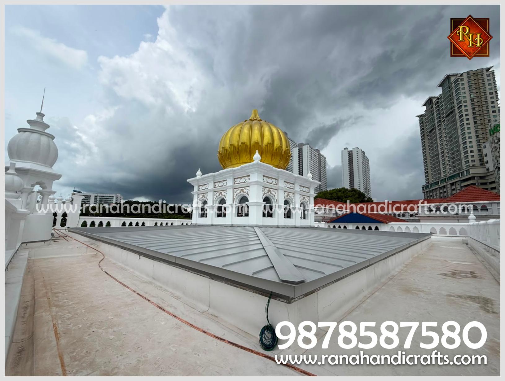 A wide shot showing the golden dome on the roof of Wadda Gurdwara Sahib Penang, with the surrounding urban landscape visible in the background.