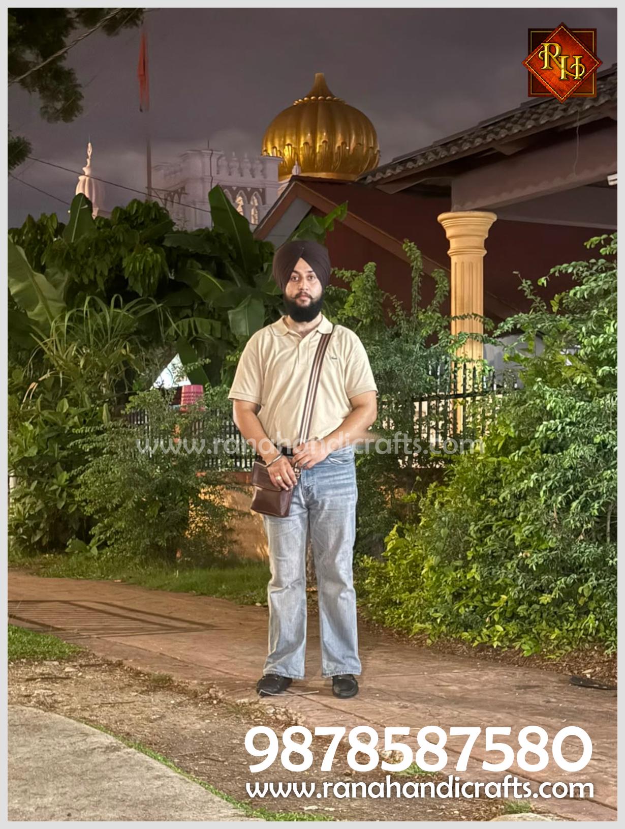 Uday Veer Singh Rana standing in front of the Wadda Gurdwara Sahib in Penang, Malaysia, following the successful installation of a 20ft golden dome manufactured by Rana Handicrafts International.
