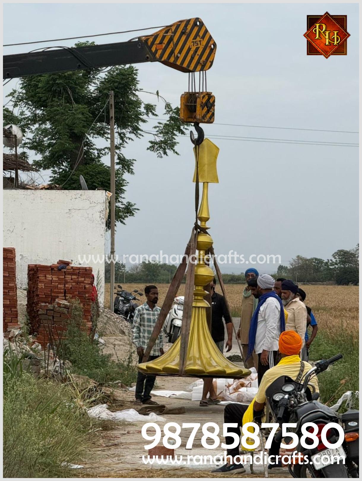 Crane lifting the 16ft golden dome during installation process at Hoshiarpur