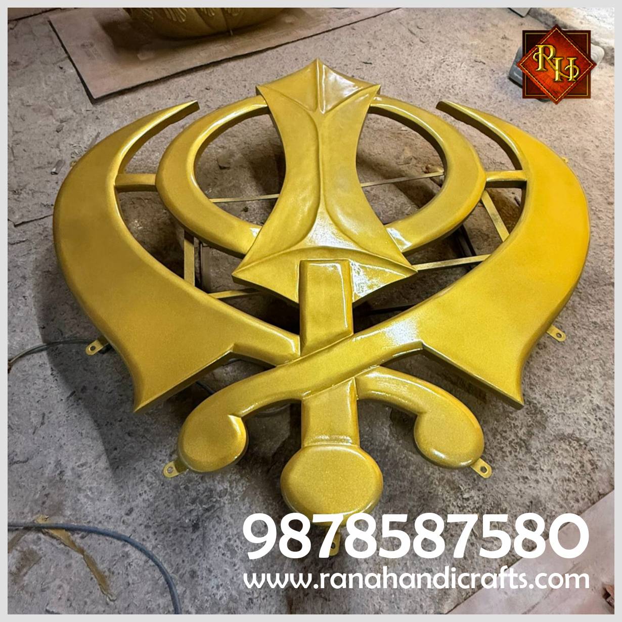 7ft x 7ft golden silicon fiber Khanda reinforced with MS Framing laying on a workshop floor.