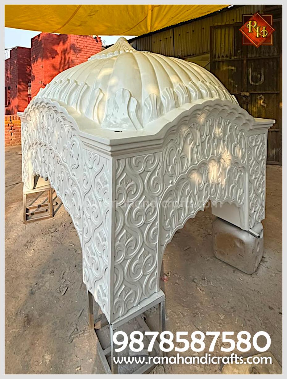 Angular view of the white Palki Sahib dome / gumbad showing the decorative arches and carvings