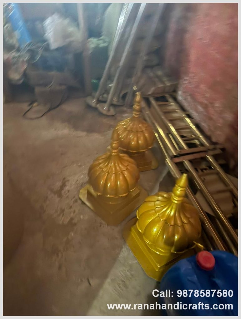 Three finished 1ft golden domes for the UK, resting on the workshop floor, manufactured by Rana Handicrafts International using high quality silicon fiber