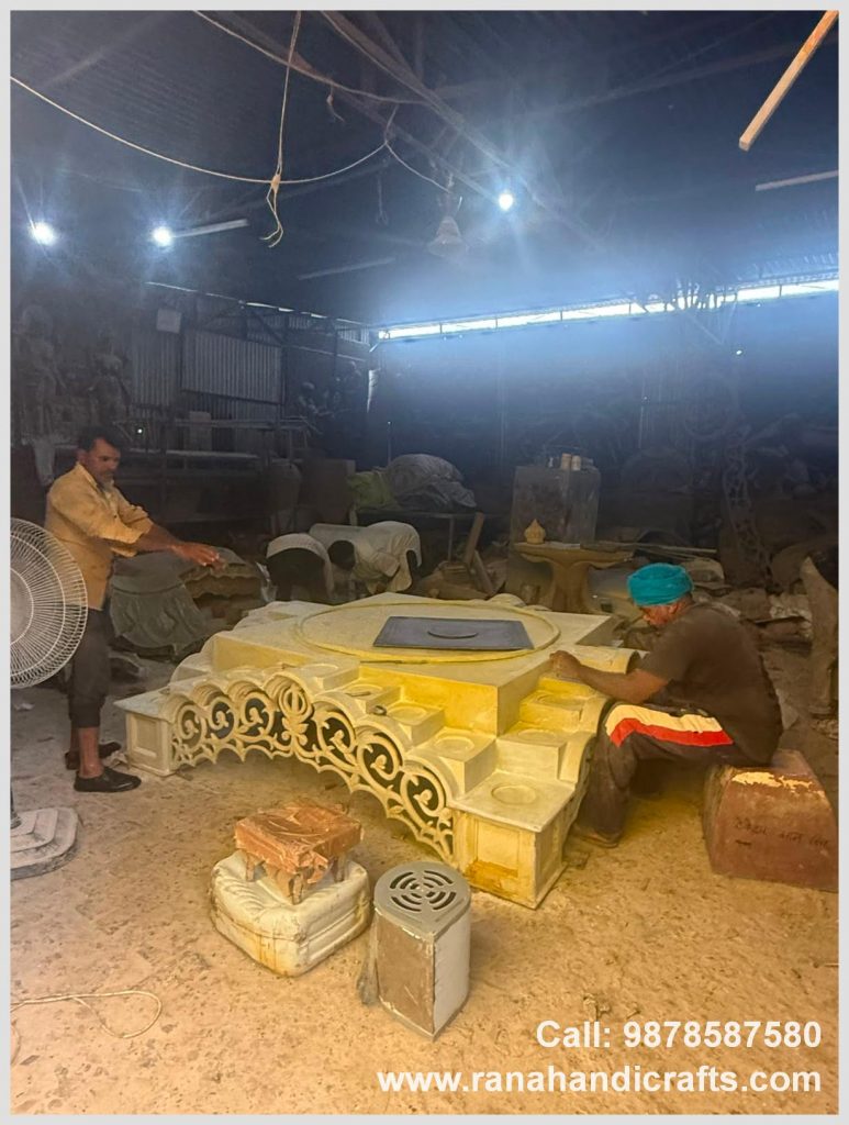 Artisan meticulously hand-carving the detailed base of a large 7ftx7ft Palki Sahib for Canada, in the Rana Handicrafts International workshop using high quality silicon fiber