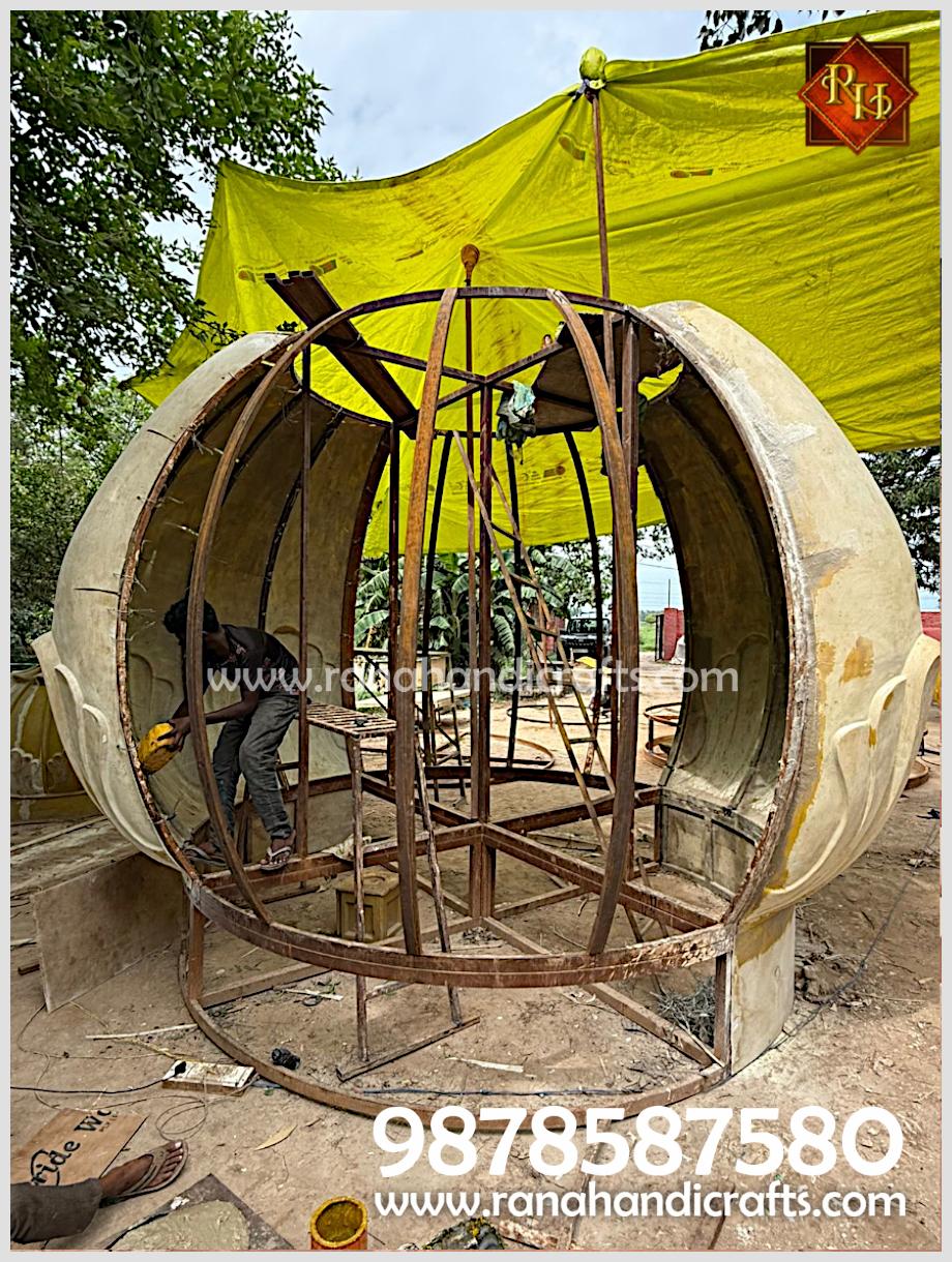 Worker assembling and finishing the structural framework and panels of the 14ft diameter dome by Rana Handicrafts International.